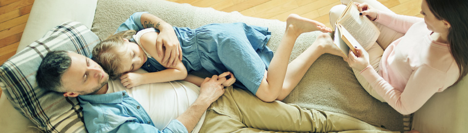 Picture of a family cuddling in a sofa